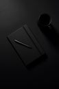 Black Notebook, Pen, Coffee: Minimalist Dark Desk Setup Royalty Free Stock Photo