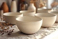Minimalist design of ceramic bowls on table in kitchen. Subtle texture beneath touch as evidence of artisan handiwork Royalty Free Stock Photo