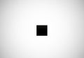 A minimalist design featuring a small black square centered on a plain white background. The stark Royalty Free Stock Photo