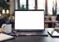 A minimalist desk in a school classroom with a modern laptop with a white screen Royalty Free Stock Photo