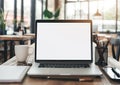 A minimalist desk in a school classroom with a modern laptop with a white screen Royalty Free Stock Photo