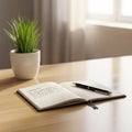 A minimalist desk setup features an open notebook with cursive writing, accompanied by a sleek Royalty Free Stock Photo