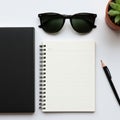 A minimalist desktop layout featuring a black hardcover notebook, a small spiral-bound notebook Royalty Free Stock Photo