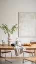 Minimalist dining table with white vase and greenery Royalty Free Stock Photo