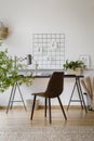 Minimalist drawings pinned to an organizer on a white wall in a