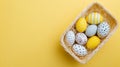 Minimalist Easter Basket with Decorated Eggs on Bright Yellow Background Flat Lay Royalty Free Stock Photo