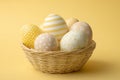 Minimalist Easter Basket with Decorated Eggs on a Soft Yellow Background Springtime Still Life Royalty Free Stock Photo