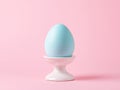 Minimalist Easter composition with a single pastel egg on a white stand Royalty Free Stock Photo