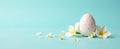 Minimalist Easter composition with white egg and delicate white flowers on pastel blue background with copy space Royalty Free Stock Photo