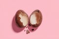 Minimalist easter concept half broken chocolate egg on soft pink background with creative space Royalty Free Stock Photo