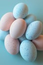 Minimalist Easter Stack of Pastel Blue and Pink Speckled Eggs on Light Blue Background Royalty Free Stock Photo
