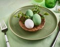 A minimalist Easter table setting with an emphasis on natural materials and a fresh green palette Royalty Free Stock Photo