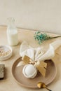 Minimalist eco beige monochrome table decor for the Easter holiday. Easter bunny from a napkin. Natural ingredients of the table