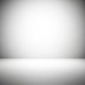 A minimalist, empty room with smooth, light gray walls and floor creating a seamless transition. Royalty Free Stock Photo