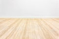 Minimalist empty room with wooden floor and white wall.