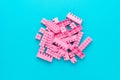 Minimalist flat lay photo of pink plastic blocks with copy space