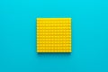 Minimalist flat lay photo of yellow plastic blocks with copy space