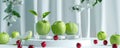 A minimalist fruit podium setup with a glass podium surrounded by green apples and red cherries.