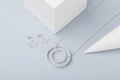 Minimalist geometric silver necklace and circle stud earrings on