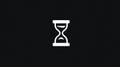 Minimalist White Hourglass Icon Centered on a Deep Black Solid Background Symbolizing Time Royalty Free Stock Photo