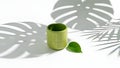Minimalist Green Bamboo Cup with Leaf and Shadow Play Royalty Free Stock Photo