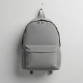 Minimalist grey backpack hanging on a hook Royalty Free Stock Photo