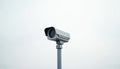 Minimalist grey security camera mounted on pole against plain white background. Modern surveillance technology device for Royalty Free Stock Photo