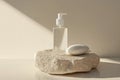 Minimalist hand sanitizer bottle resting on a small pebble platform