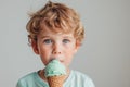 Minimalist High-Stock-Style Image Young Boy Enjoying Mint Chocolate Ice Cream On A White Background