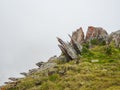 Minimalist highland scenery with sharpened stones of unusual shape. Awesome scenic mountain landscape with big cracked pointed