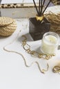 Minimalist home aesthetics. Fashion jewellery and candles setting on white background.