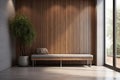 Minimalist home interior design of modern entrance hall with glass door. Grey leather bench near wood paneling wall in hallway