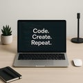Minimalist Home Office Desk with Laptop Displaying Code Create Repeat Text for Programmers and Developers Royalty Free Stock Photo