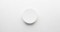 Minimalist image featuring a plain, smooth white circular object centered on a white Royalty Free Stock Photo