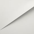 A minimalist image featuring two sheets of plain white paper, one overlaid diagonally Royalty Free Stock Photo