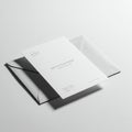 A minimalist invitation card sits atop a matching envelope on a white surface. The Royalty Free Stock Photo