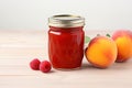 A minimalist jar of homemade raspberry peach jam and fresh fruit