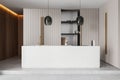 A minimalist kitchen interior with a large central island, wooden accents, and modern pendant lights, set against a neutral