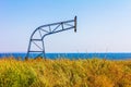 Landscape of an old shield for a basketball hoop on an abandoned basketball court on a background of blue sea and sky on a summer