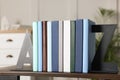 Minimalist letter bookends with books on shelf indoors