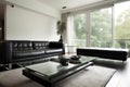 minimalist living room with sleek black leather sofa and glass coffee table Royalty Free Stock Photo