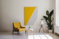 Minimalist living room with yellow armchair and modern artwork