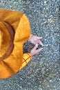 Minimalist low angle view of kid playing with sand. Childhood creativity concept