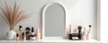 Minimalist makeup studio setup featuring a white table mirror and various beauty products. Cosmetics are on display creating a Royalty Free Stock Photo