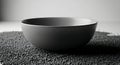 Minimalist Monochrome Ceramic Bowl on Textured Surface, Soft Lighting, Still Life Royalty Free Stock Photo