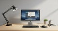 A minimalist office desk setup features a sleek iMac with an open application, a black keyboard, Royalty Free Stock Photo