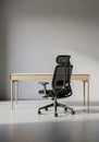 A minimalist office setting with a sleek black ergonomic chair featuring a high back an Royalty Free Stock Photo