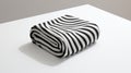 Minimalist Optical Illusion: Black And White Striped Blanket On White Table Royalty Free Stock Photo