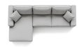 Overhead view reveals a modern light gray fabric sectional sofa with comfortable square throw pillows isolated against a bright Royalty Free Stock Photo