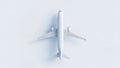 Minimalist overhead view of a white airplane model on a light blue background Royalty Free Stock Photo